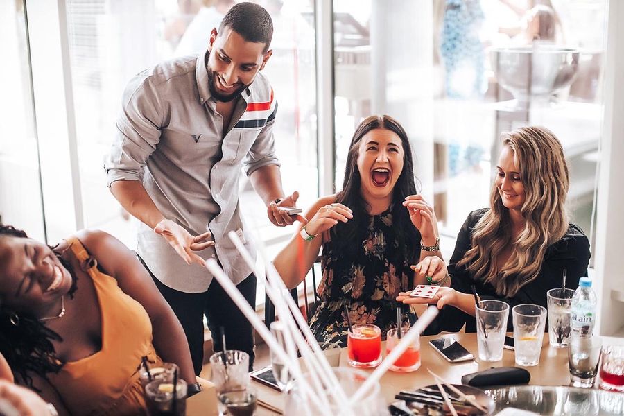 Amazed guests during a table magic trick